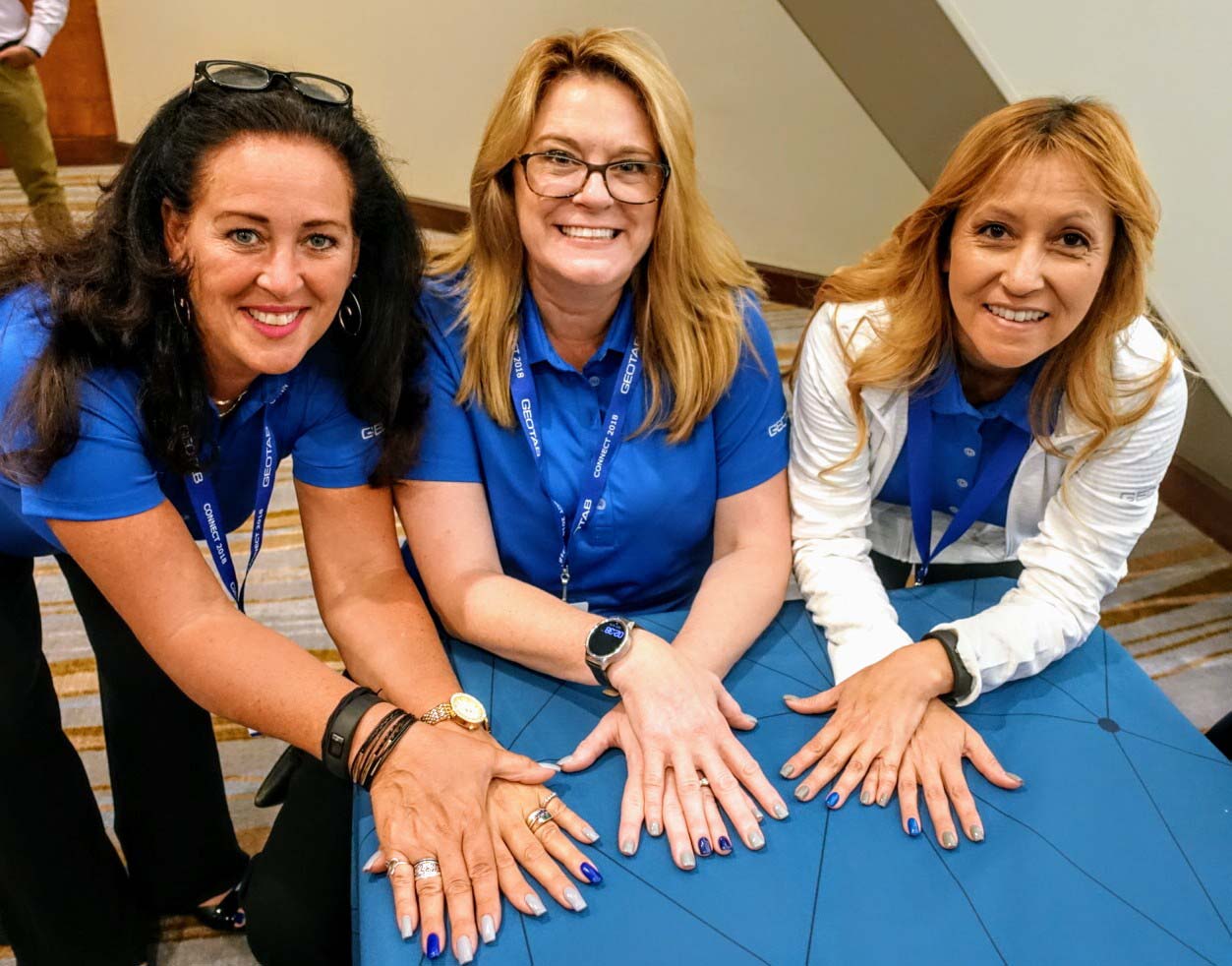 tephanie Voelker with two female colleagues at a conference.