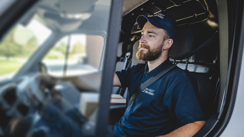 driver with his hands on steering wheel