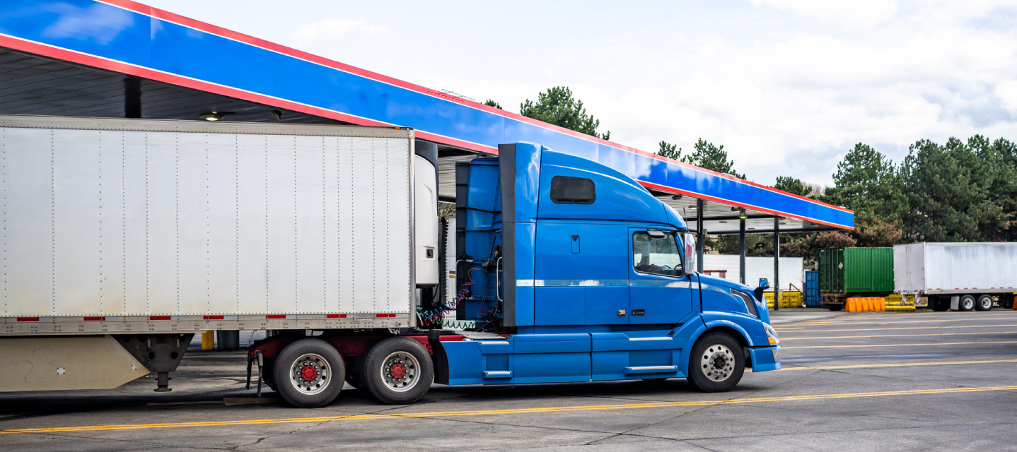 a blue semi truck refuelling