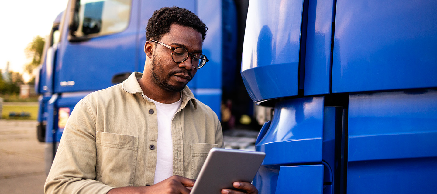 A picture of a driver using an AI-powered fleet management app.