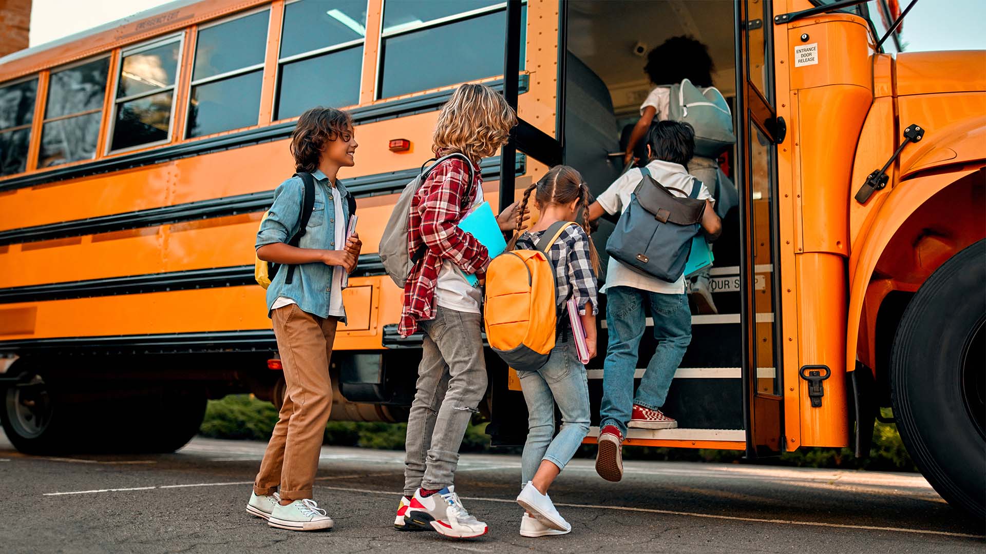 kids going into a school bus