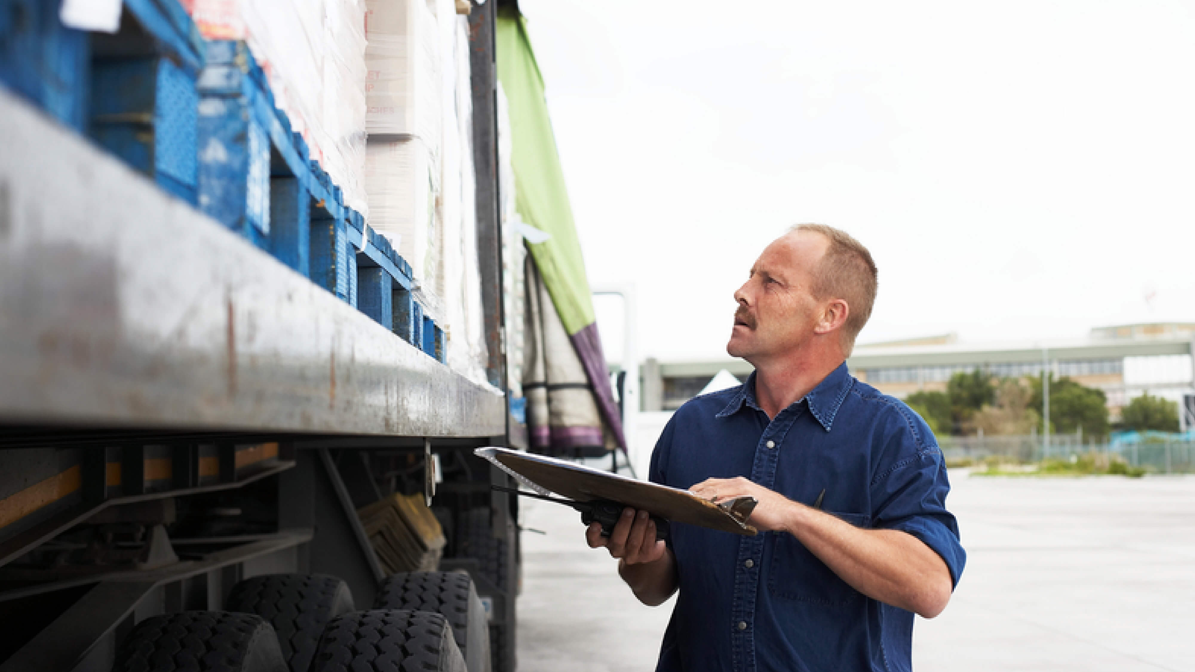 man checking on cargo on truck