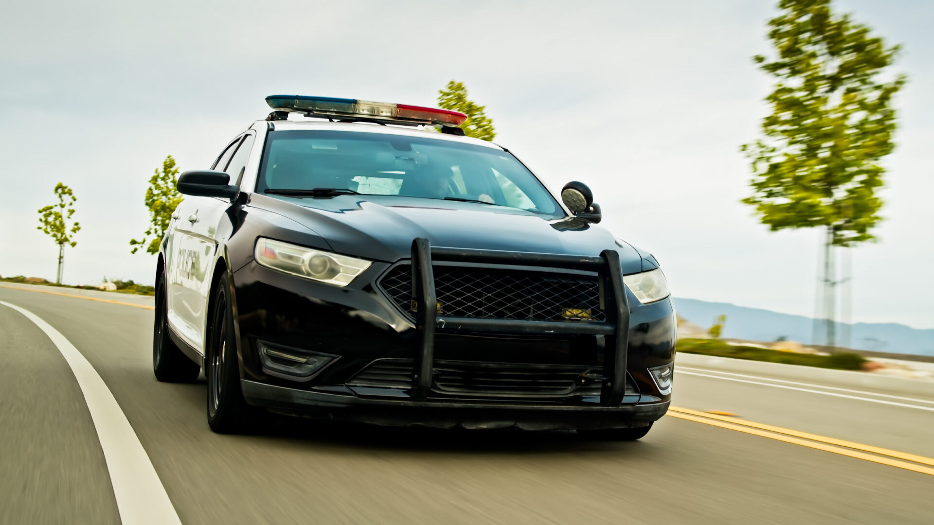 police car driving with lights on