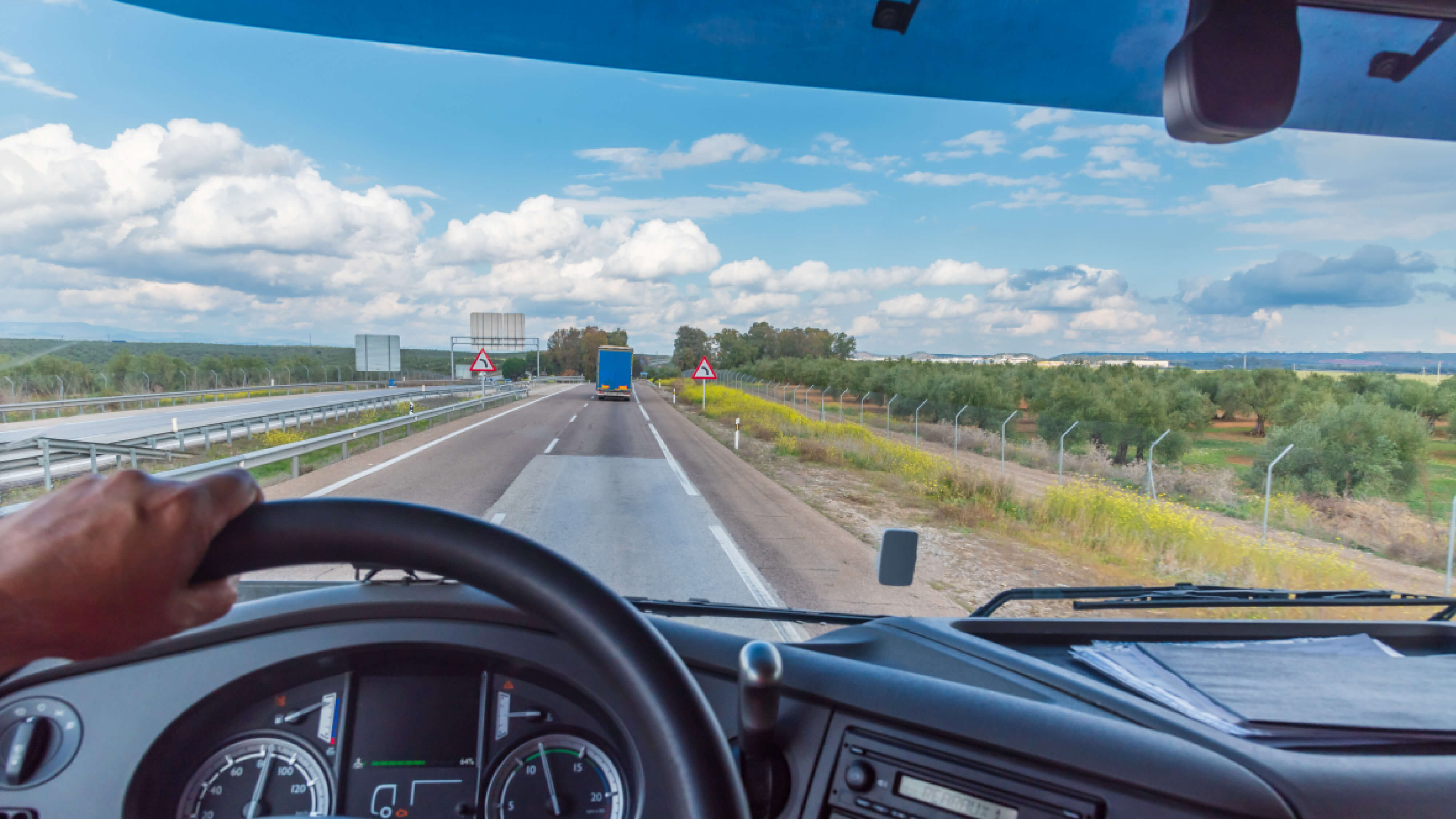 dash board view of a truck driving on a highway