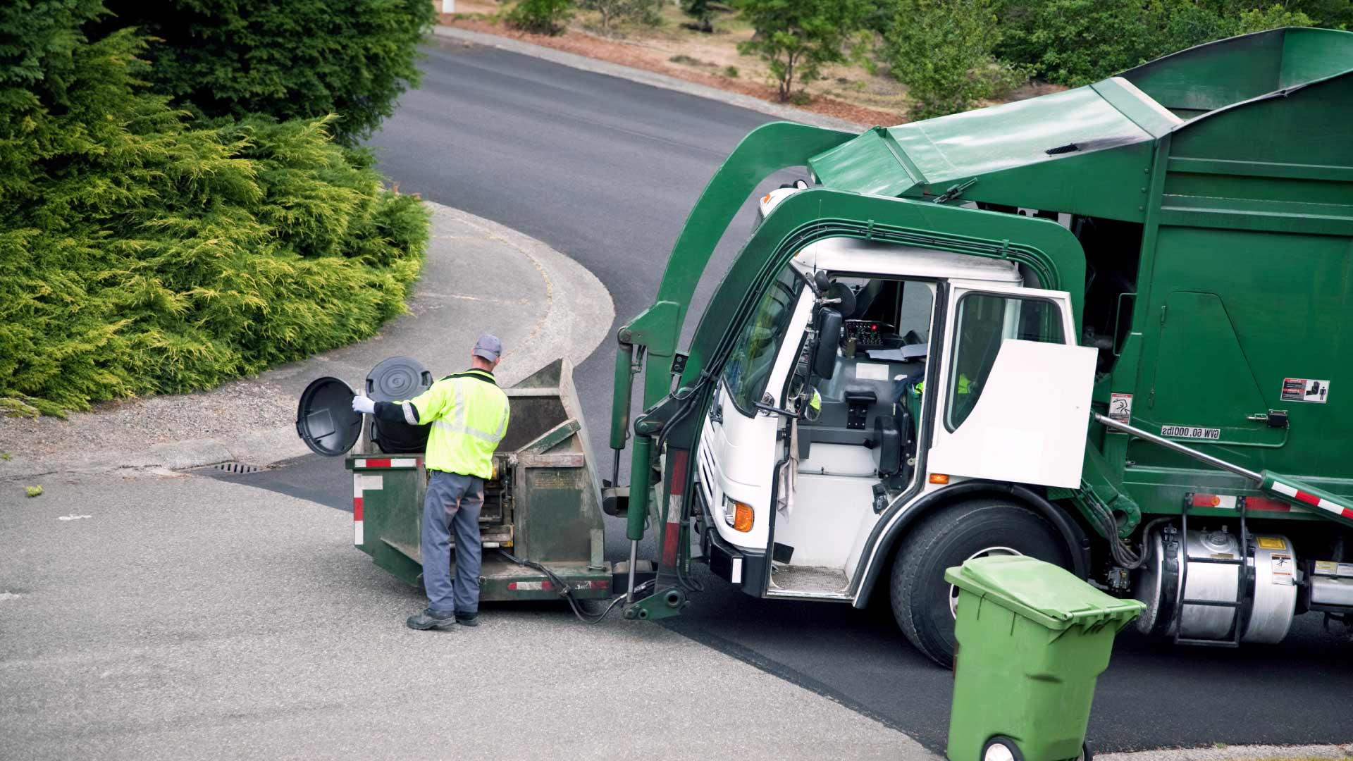 person loading garbage truck
