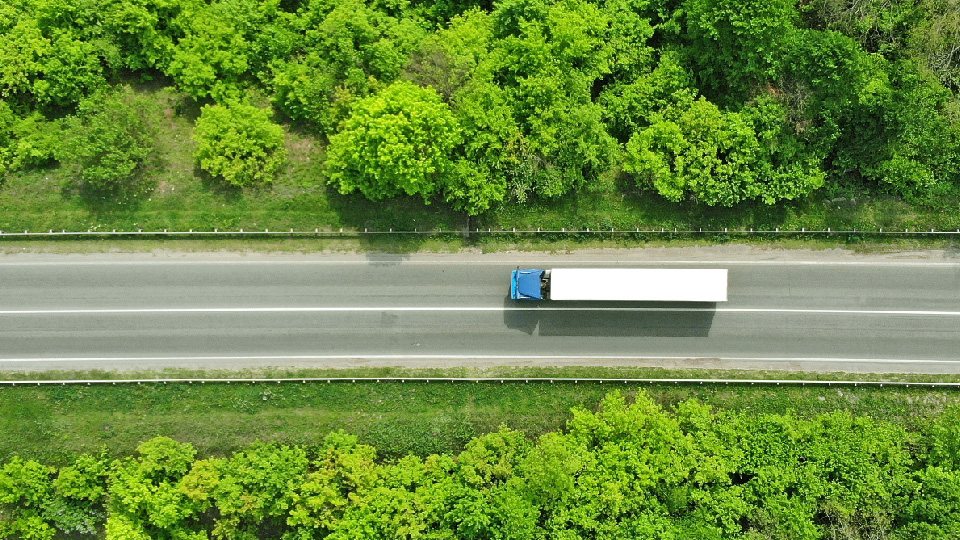 A truck driving through the forrest