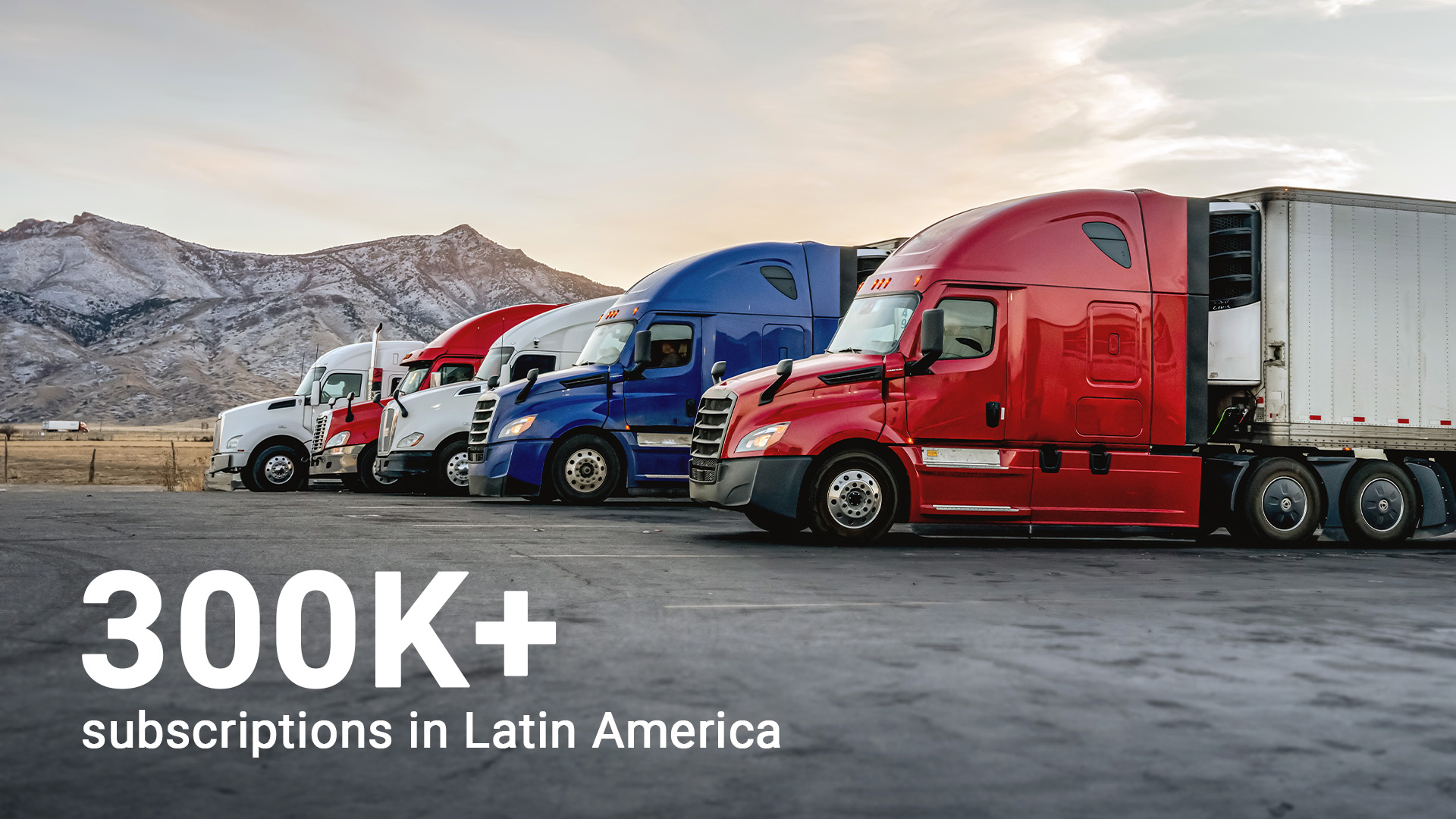 Fleet of trucks and commercial vehicles on a highway with a driver reviewing data inside the cab (fleet performance and optimized routes).