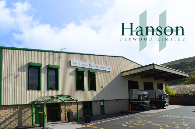 Green and beige building with green entrance awning and company logo in right hand corner.