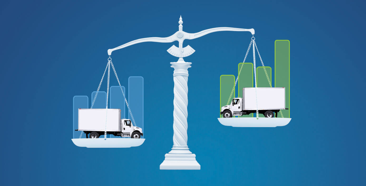 Scale holding a transport truck on each weighing plate with graphs behind them. 